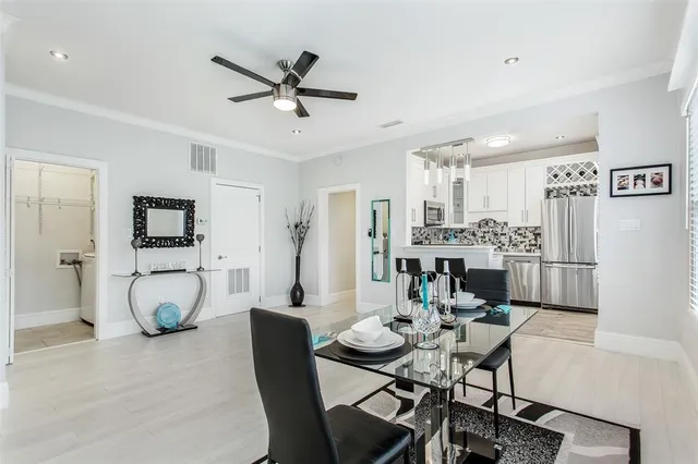 a view of a dining room with furniture and a potted plant