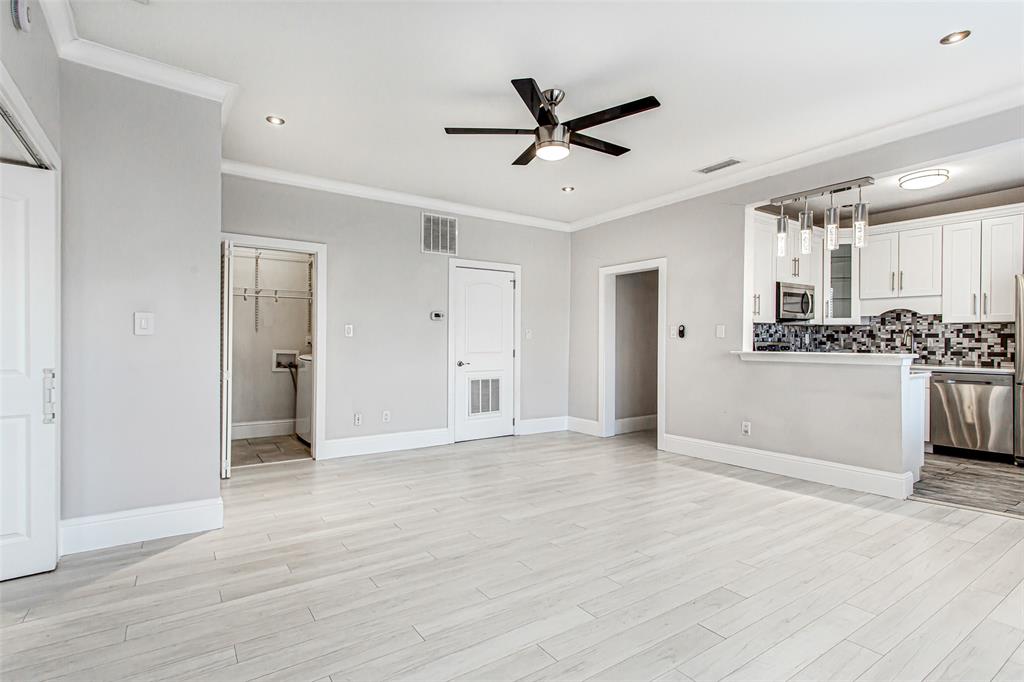 4719 Junius Street, Unit 3 Dallas, TX 75246 - Photo 11 of 38 a view of a kitchen with a sink and wooden floor