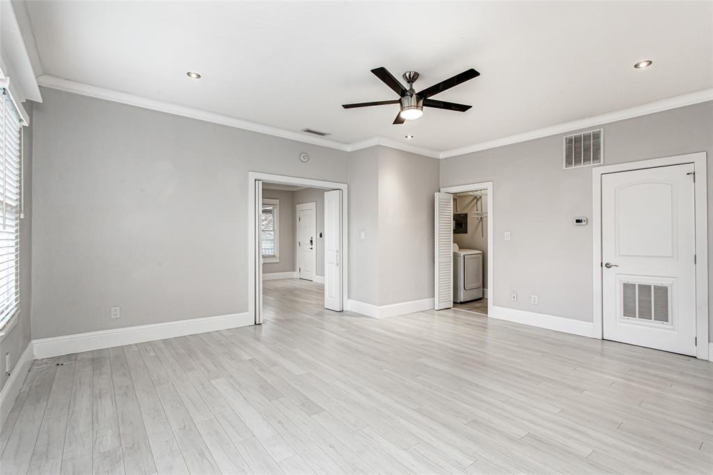 4719 Junius Street, Unit 3 Dallas, TX 75246 - Photo 12 of 38 a view of empty room with wooden floor and window