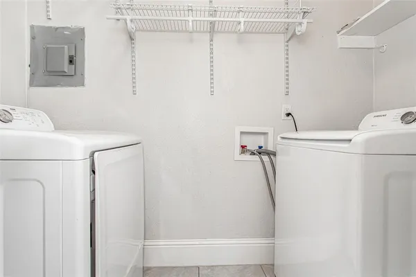 a view of storage and utility room with washer and dryer