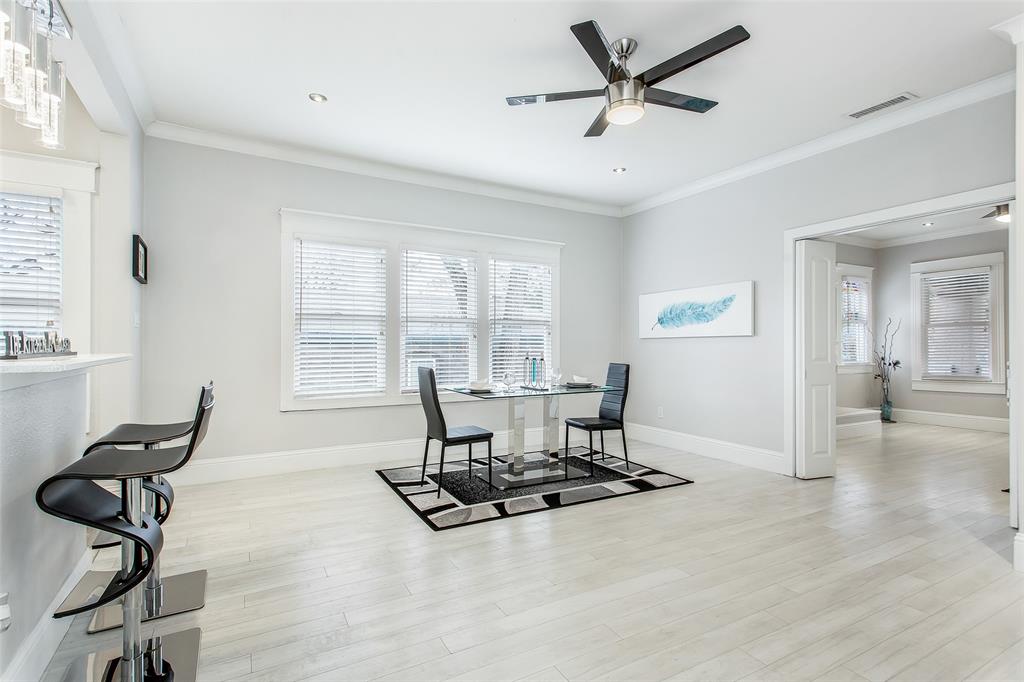 4719 Junius Street, Unit 3 Dallas, TX 75246 - Photo 14 of 36 a living room with furniture a floor to ceiling window and a ceiling fan