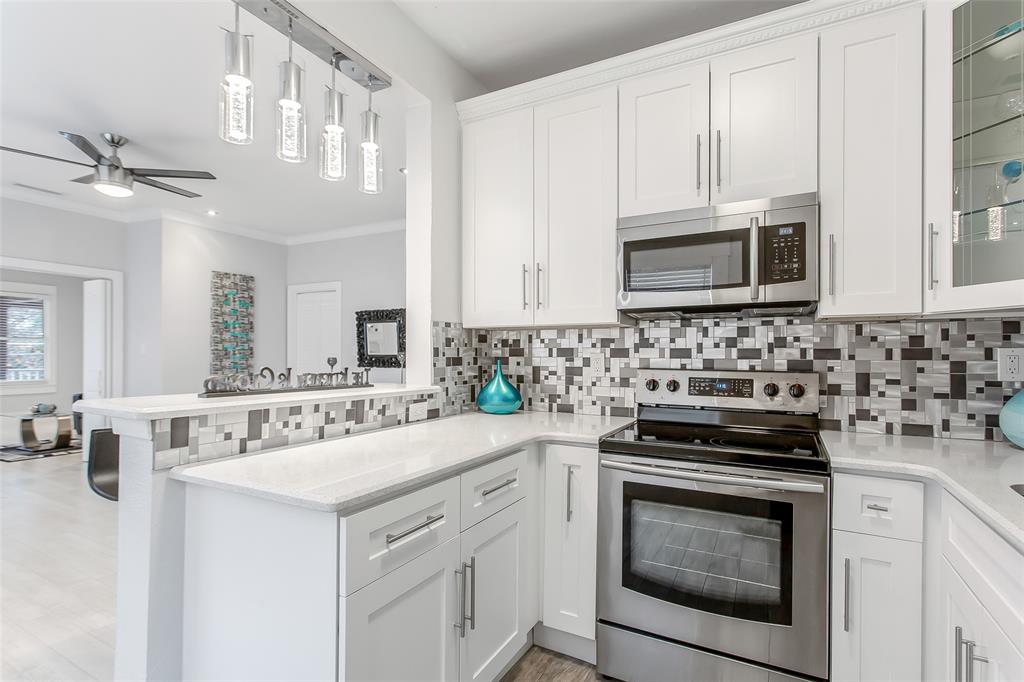 4719 Junius Street, Unit 3 Dallas, TX 75246 - Photo 16 of 36 a kitchen with cabinets stainless steel appliances a sink and a counter space