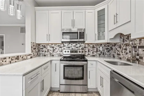 a kitchen with a sink stove and microwave