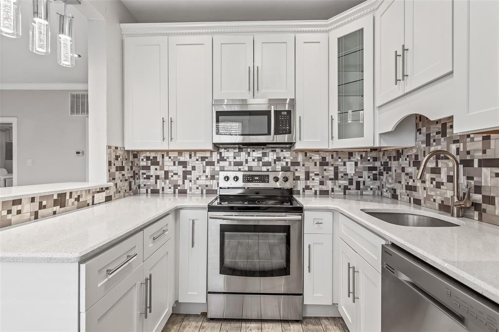 4719 Junius Street, Unit 3 Dallas, TX 75246 - Photo 18 of 38 a kitchen with cabinets appliances a sink and a counter top