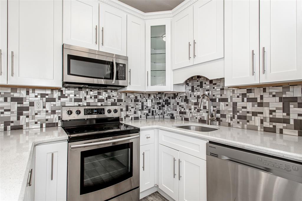 4719 Junius Street, Unit 3 Dallas, TX 75246 - Photo 19 of 38 a kitchen with a sink stove and microwave