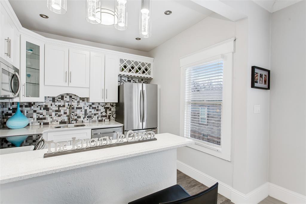 4719 Junius Street, Unit 3 Dallas, TX 75246 - Photo 19 of 36 a bathroom with a sink and a mirror
