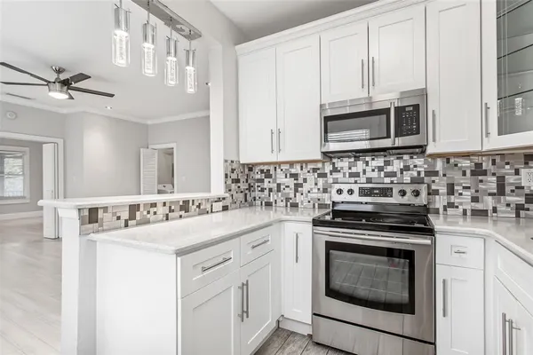 a kitchen with stainless steel appliances a refrigerator sink and cabinets
