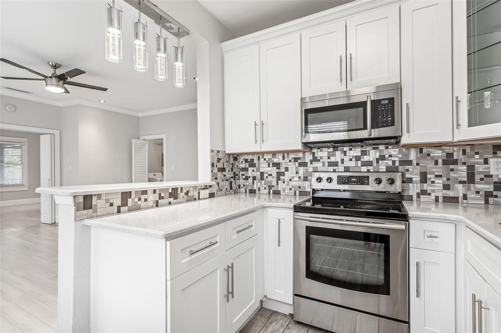 4719 Junius Street, Unit 3 Dallas, TX 75246 - Photo 20 of 38 a kitchen with stainless steel appliances a stove sink and cabinets