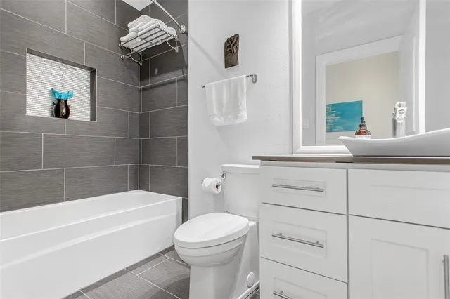 a bathroom with a sink a toilet and bathtub