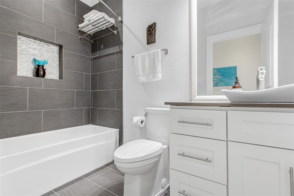 4719 Junius Street, Unit 3 Dallas, TX 75246 - Photo 20 of 36 a bathroom with a sink a toilet and bathtub