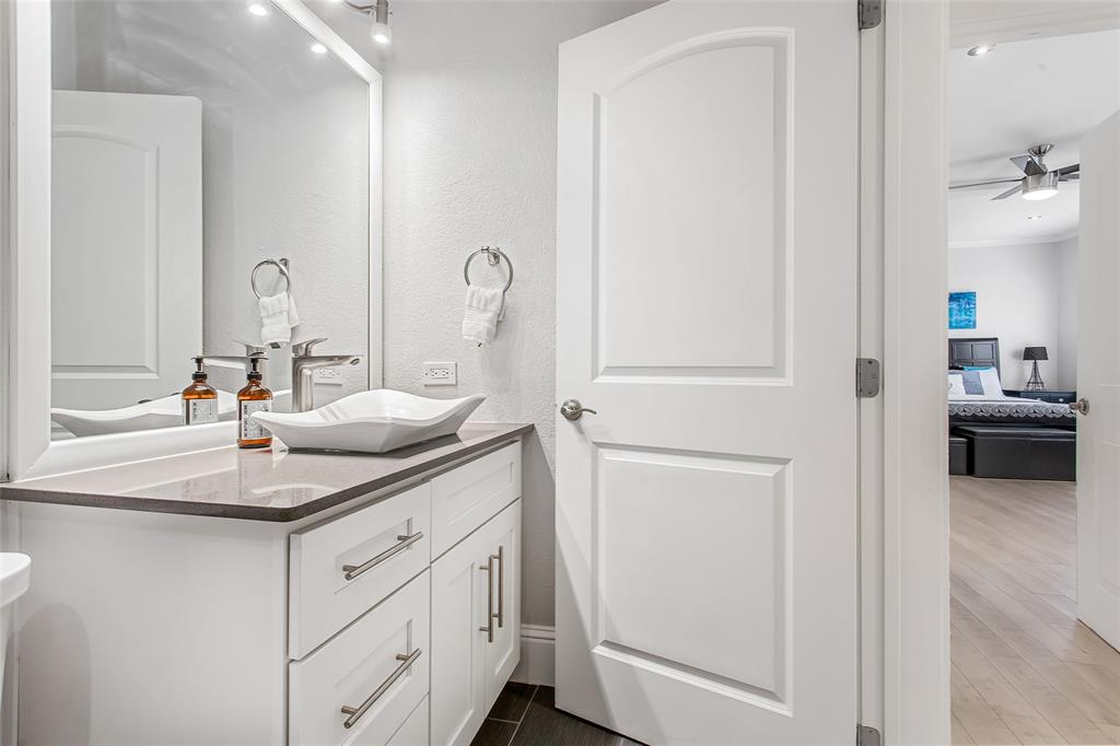 4719 Junius Street, Unit 3 Dallas, TX 75246 - Photo 21 of 36 a bathroom with a sink and a mirror