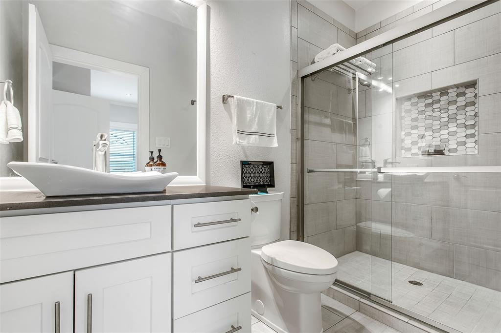 4719 Junius Street, Unit 3 Dallas, TX 75246 - Photo 22 of 36 a bathroom with a sink a toilet and shower