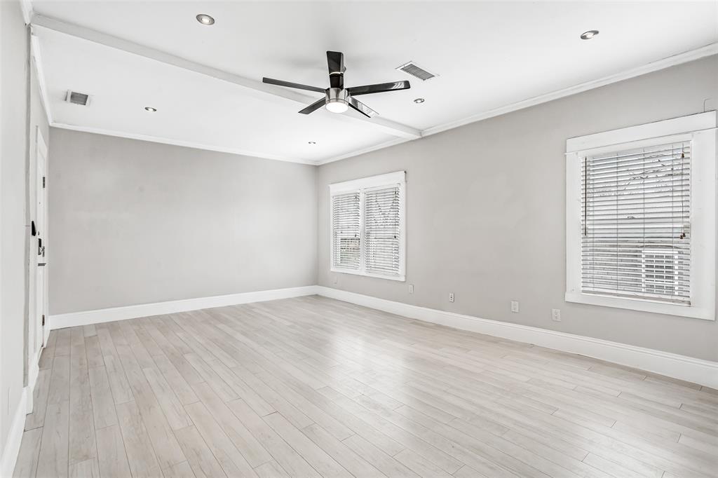 4719 Junius Street, Unit 3 Dallas, TX 75246 - Photo 24 of 38 a view of an empty room with wooden floor and a window