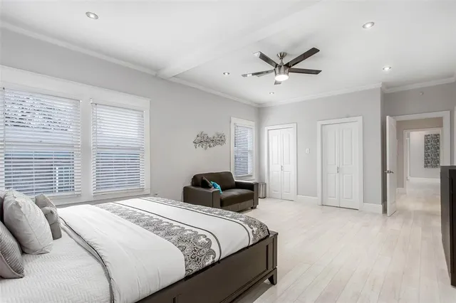 a bedroom with a bed and a ceiling fan