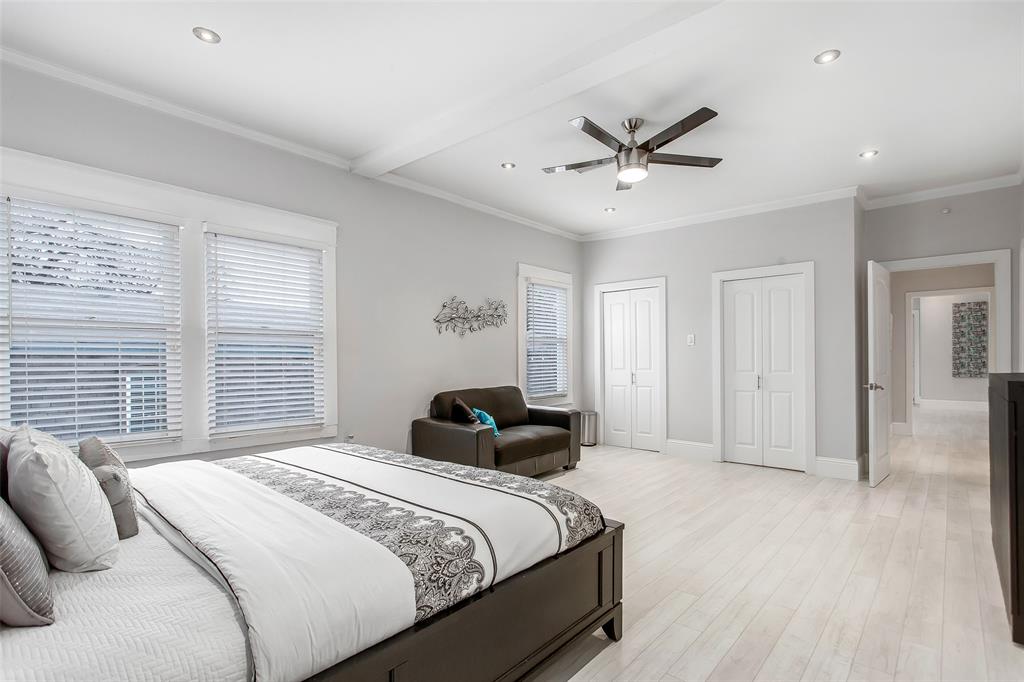 4719 Junius Street, Unit 3 Dallas, TX 75246 - Photo 24 of 36 a bedroom with a bed and a ceiling fan