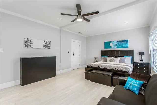 a spacious bedroom with a bed and a fireplace