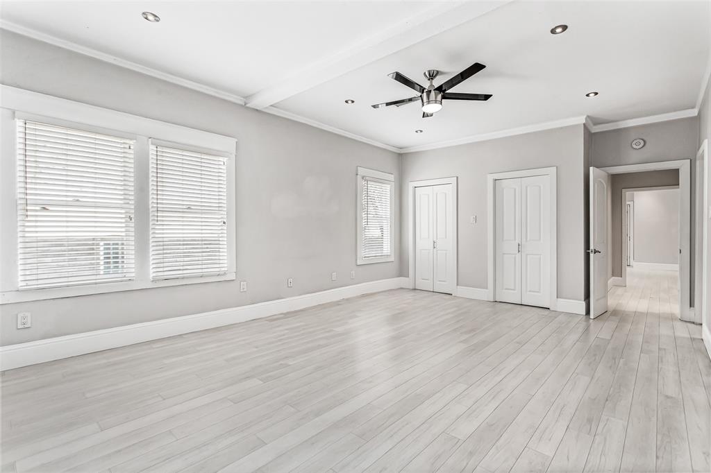 4719 Junius Street, Unit 3 Dallas, TX 75246 - Photo 26 of 38 a view of an empty room with wooden floor and a window