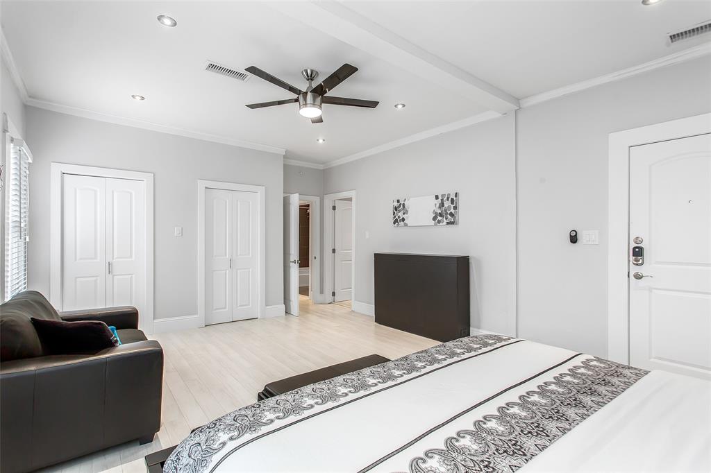 4719 Junius Street, Unit 3 Dallas, TX 75246 - Photo 27 of 36 a bedroom with a bed and a couch