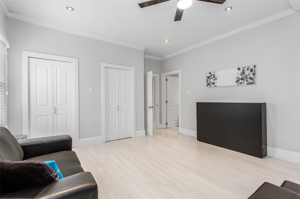 4719 Junius Street, Unit 3 Dallas, TX 75246 - Photo 28 of 36 a bedroom with furniture and a ceiling fan