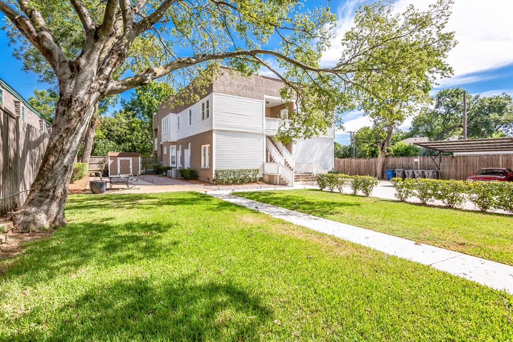 4719 Junius Street, Unit 3 Dallas, TX 75246 - Photo 30 of 38 a view of a house with a big yard and large tree