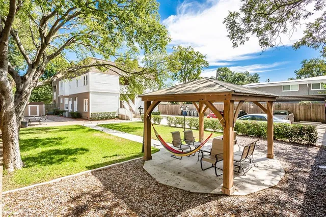 a view of a park with iron fence