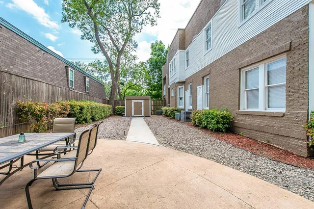 a view of backyard with outdoor seating and plants