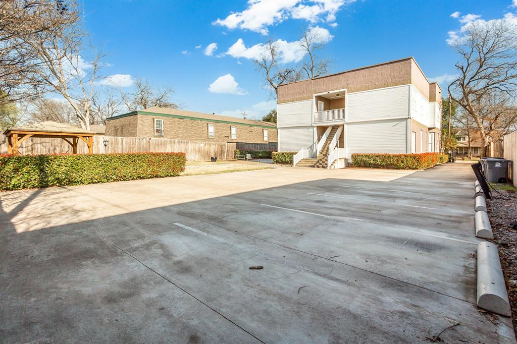 4719 Junius Street, Unit 3 Dallas, TX 75246 - Photo 35 of 38 a view of a house with a yard and garage