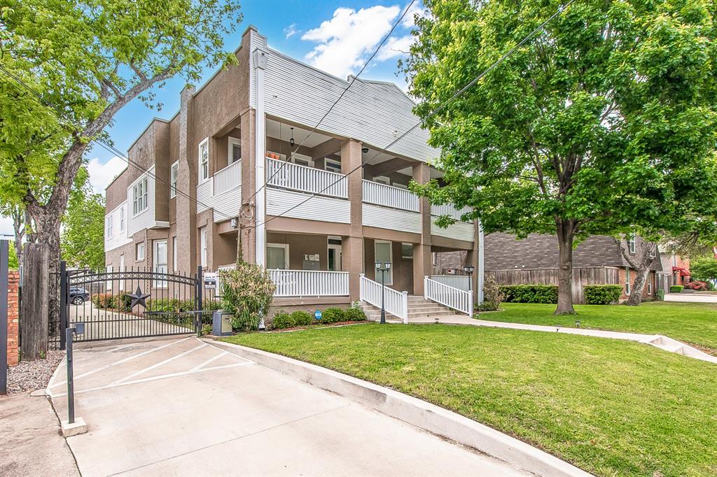 4719 Junius Street, Unit 3 Dallas, TX 75246 - Photo 38 of 38 a view of a white house with a big yard and large trees