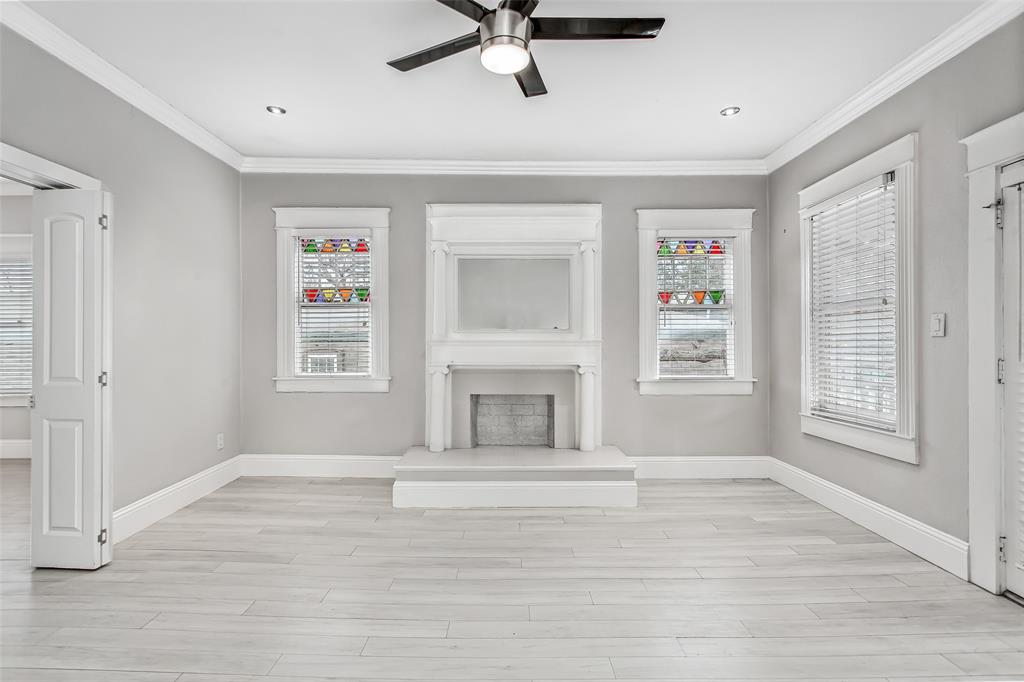 4719 Junius Street, Unit 3 Dallas, TX 75246 - Photo 4 of 38 a view of livingroom with a fireplace a ceiling fan and windows