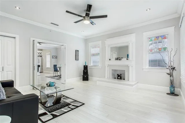 a living room with furniture a fireplace and a flat screen tv