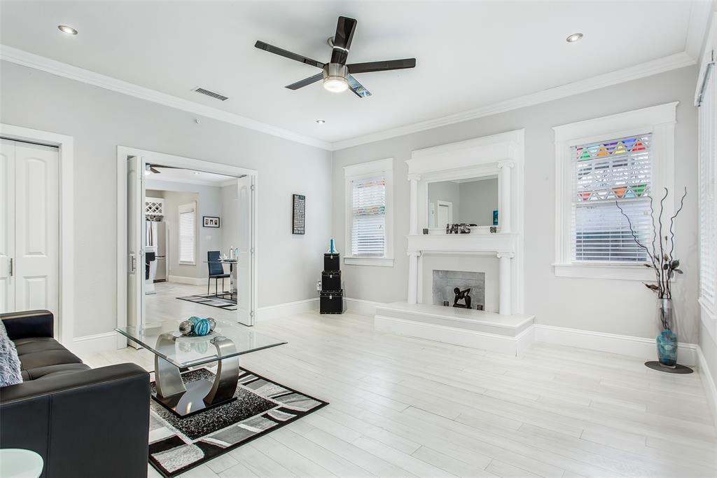 4719 Junius Street, Unit 3 Dallas, TX 75246 - Photo 4 of 36 a living room with furniture a fireplace and a flat screen tv