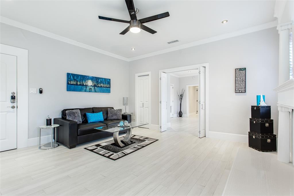 4719 Junius Street, Unit 3 Dallas, TX 75246 - Photo 6 of 36 a living room with furniture and a flat screen tv
