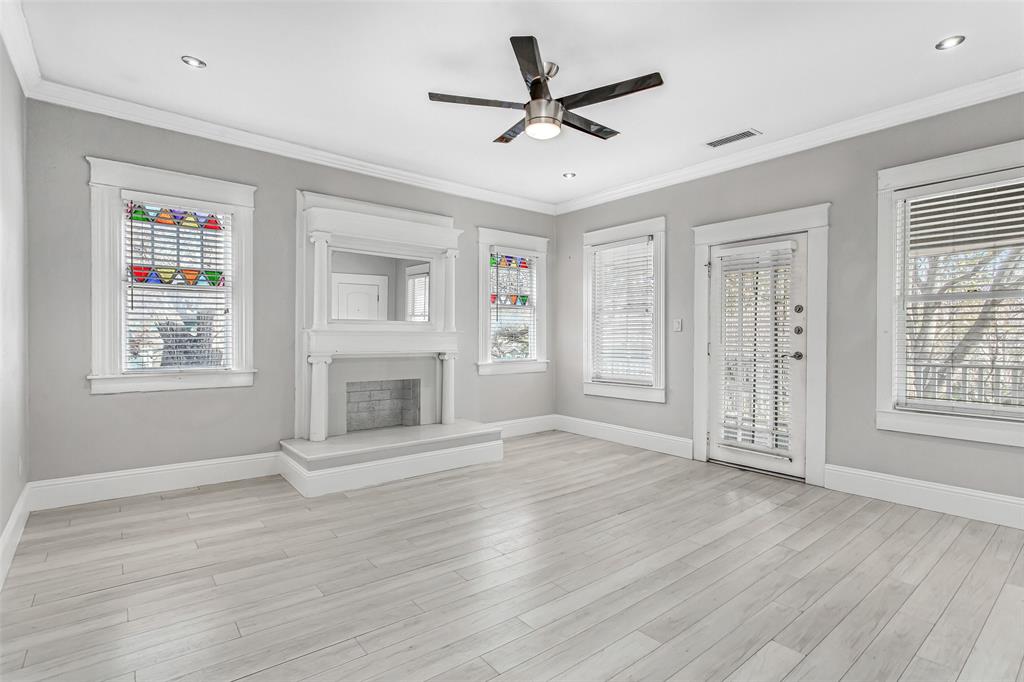 4719 Junius Street, Unit 3 Dallas, TX 75246 - Photo 6 of 38 a view of an empty room with wooden floor and a window
