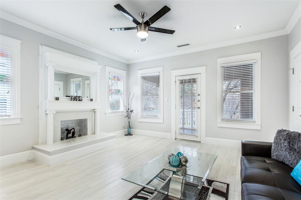4719 Junius Street, Unit 3 Dallas, TX 75246 - Photo 7 of 36 a living room with furniture and a fireplace