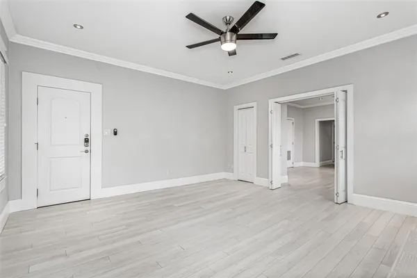 a view of an empty room with a fireplace and a window
