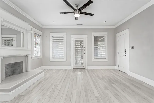 a view of a kitchen with a refrigerator and a wooden floor