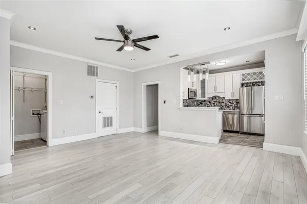 a view of a kitchen with a sink and wooden floor