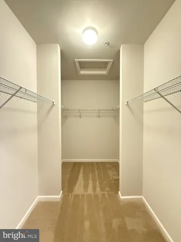 an empty room with a window and wooden floor