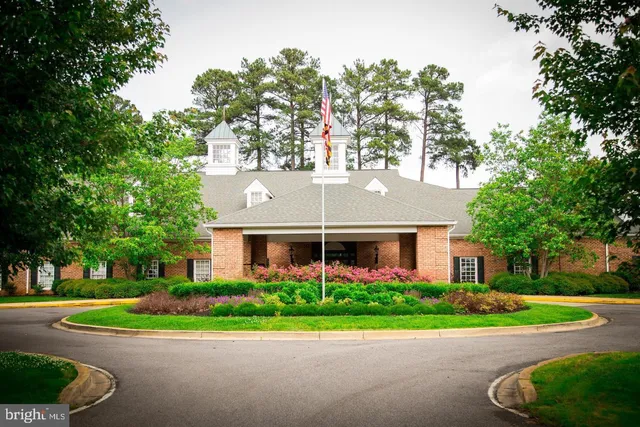 a view of a bench in the garden near a lake