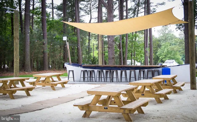 an aerial view of a house with a yard basket ball court and outdoor seating