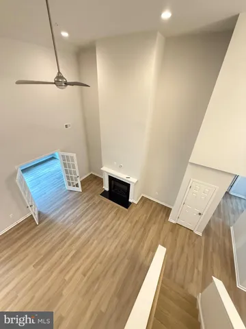 a view of an empty room with a fireplace and a window