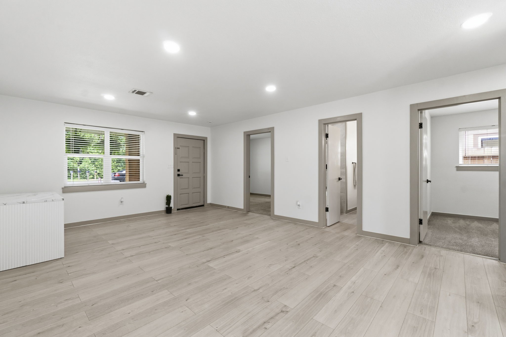 14850 Coaltown Road Willis, TX 77378 - Photo 6 of 41 Open-concept living space showcasing modern finishes, recessed lighting, and easy flow to the bedrooms and main living areas.