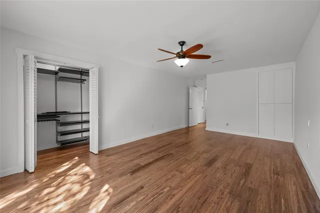 a view of a chandelier fan and wooden floor in a room