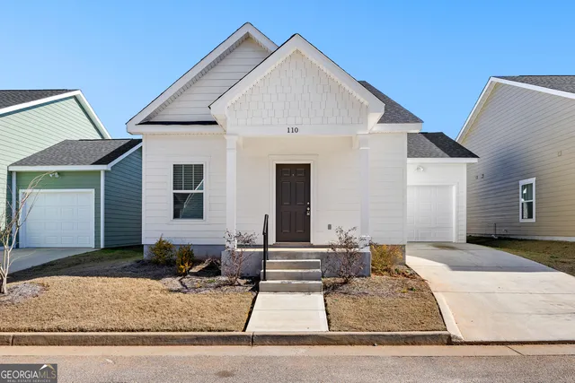 a front view of a house with garage