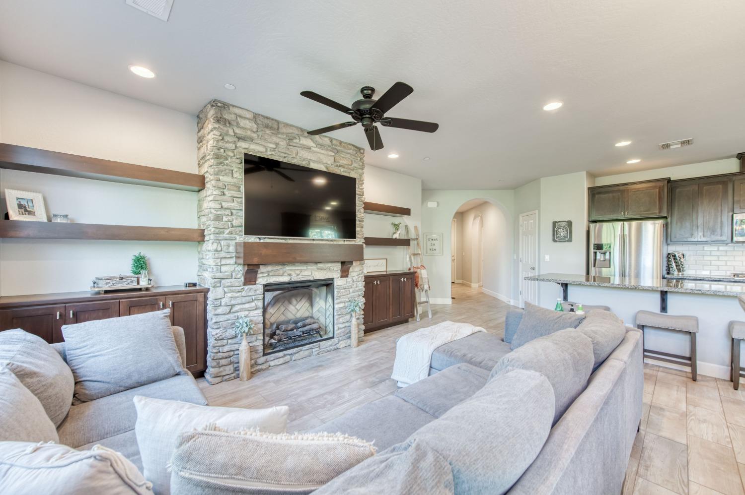 3539 Taylor Lane Clovis, CA 93619 - Photo 15 of 33 a living room with furniture a fireplace and a flat screen tv