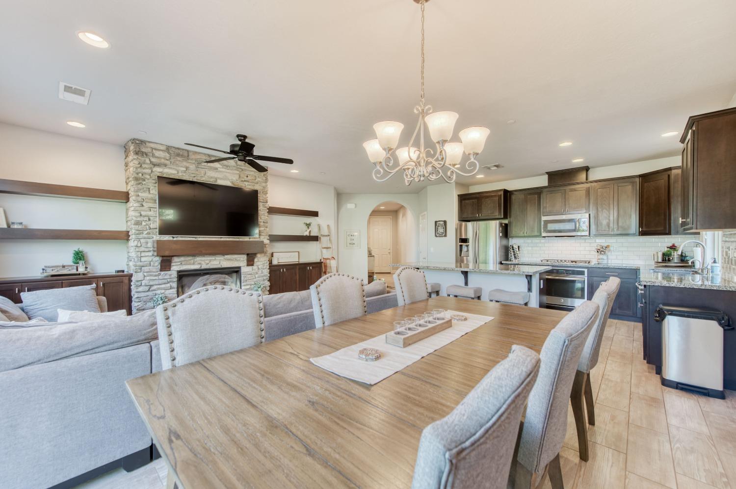 3539 Taylor Lane Clovis, CA 93619 - Photo 16 of 33 a view of a dining room with furniture a chandelier and kitchen view