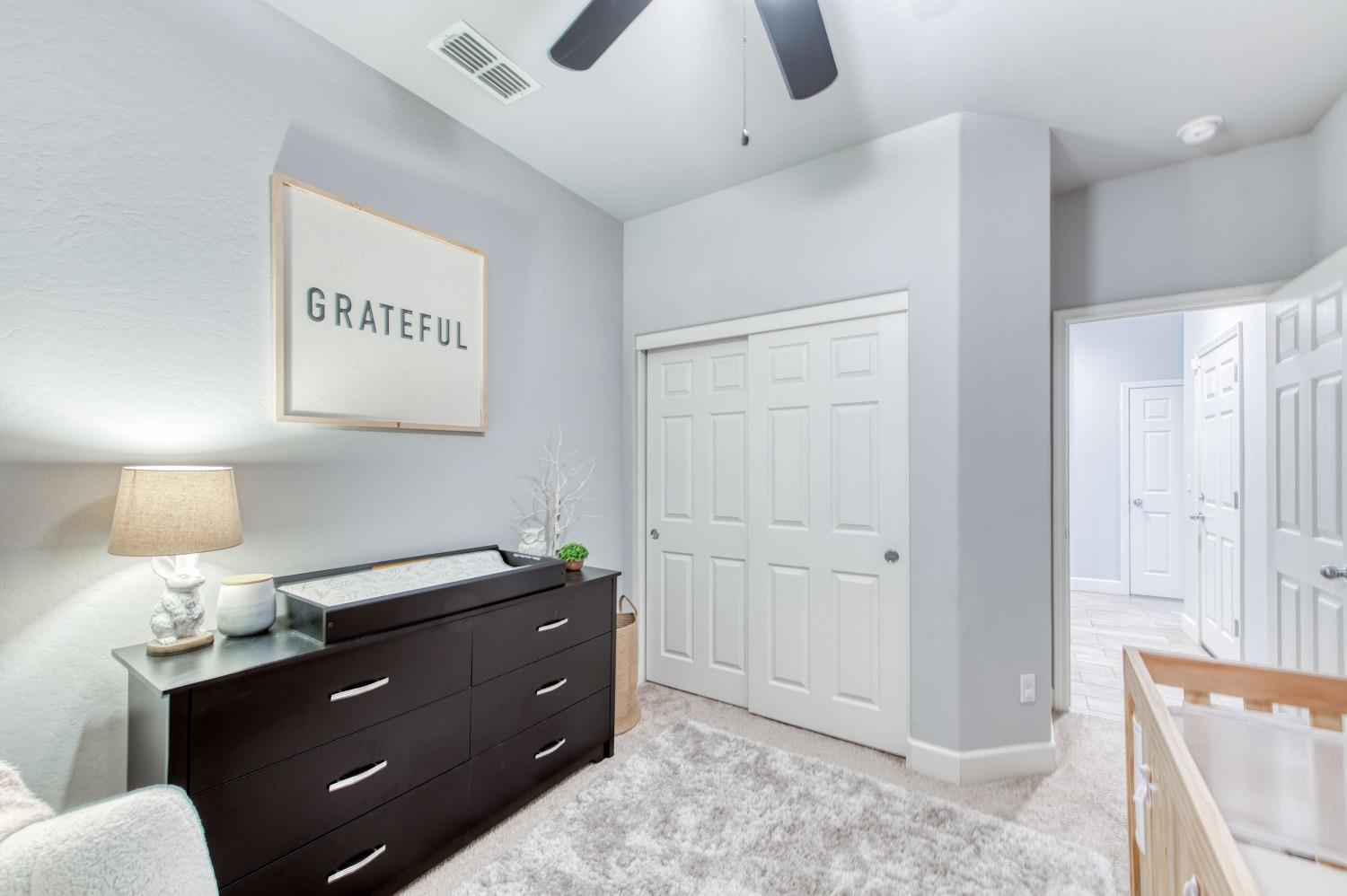 3539 Taylor Lane Clovis, CA 93619 - Photo 19 of 33 a room with a lamp and a dresser