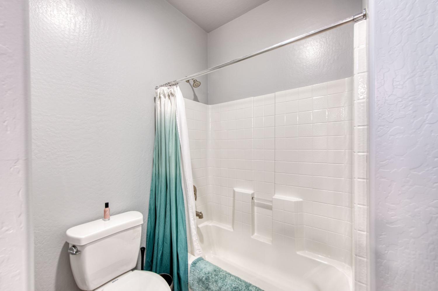 3539 Taylor Lane Clovis, CA 93619 - Photo 22 of 33 a bathroom with a toilet and a shower