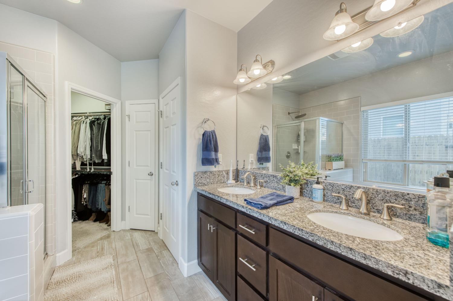 3539 Taylor Lane Clovis, CA 93619 - Photo 26 of 33 a bathroom with a granite countertop double vanity sink a mirror and shower
