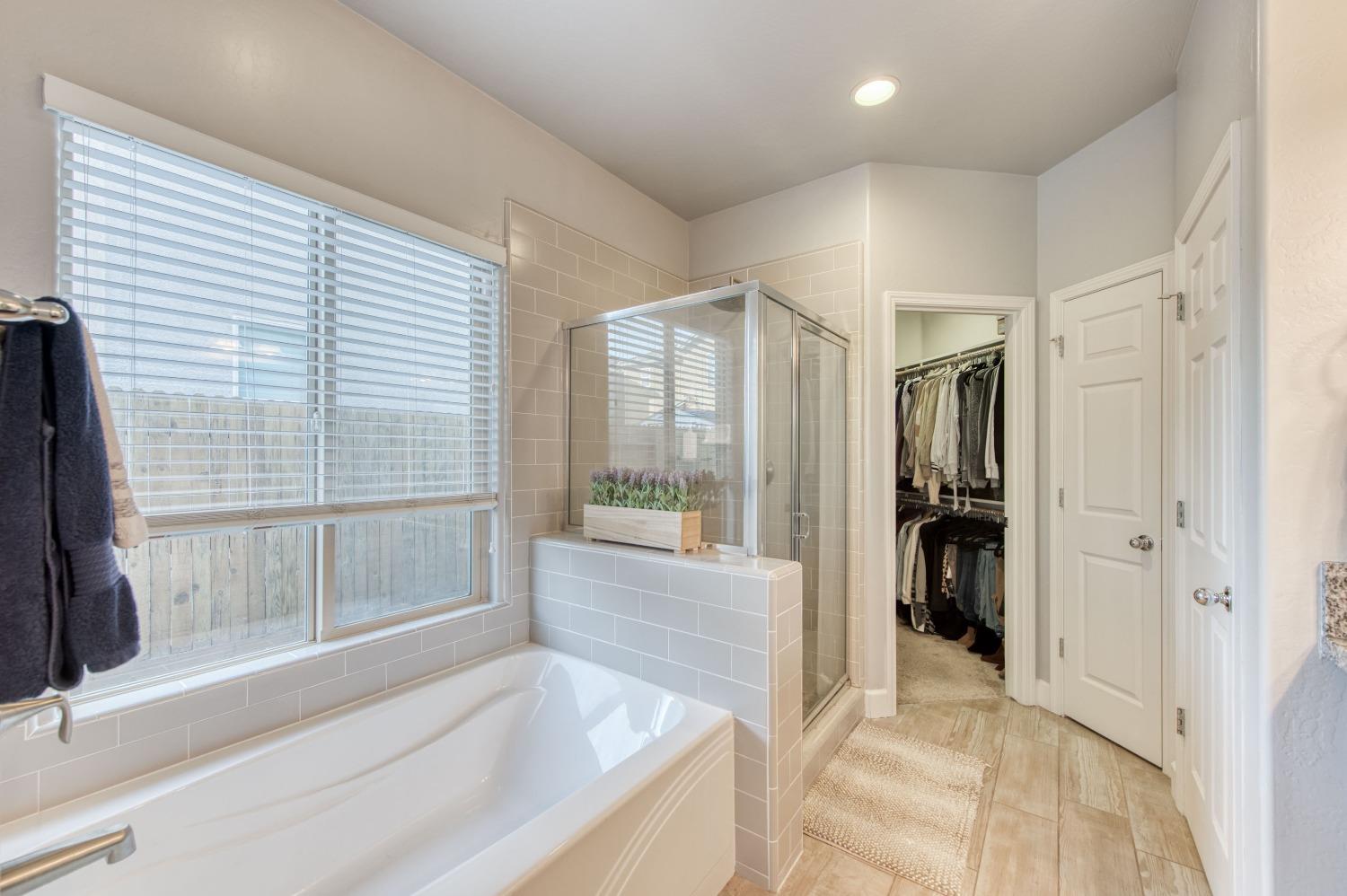 3539 Taylor Lane Clovis, CA 93619 - Photo 27 of 33 a spacious bathroom with a tub and a large window